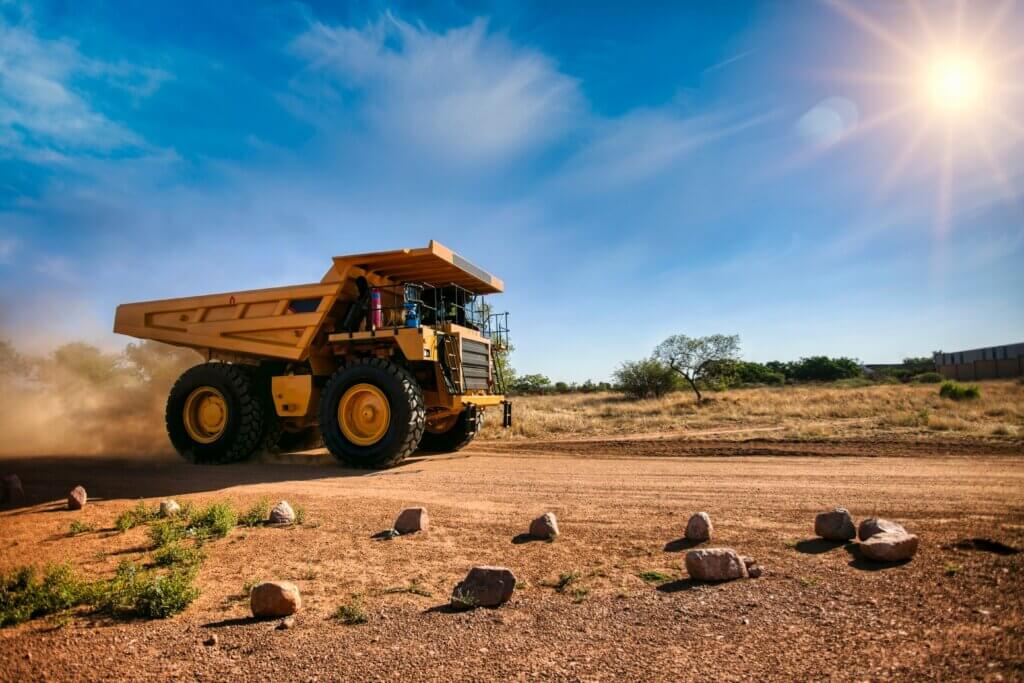 Huge,Yellow,Mining,Truck,On,A,Dirt,Road,With,A
